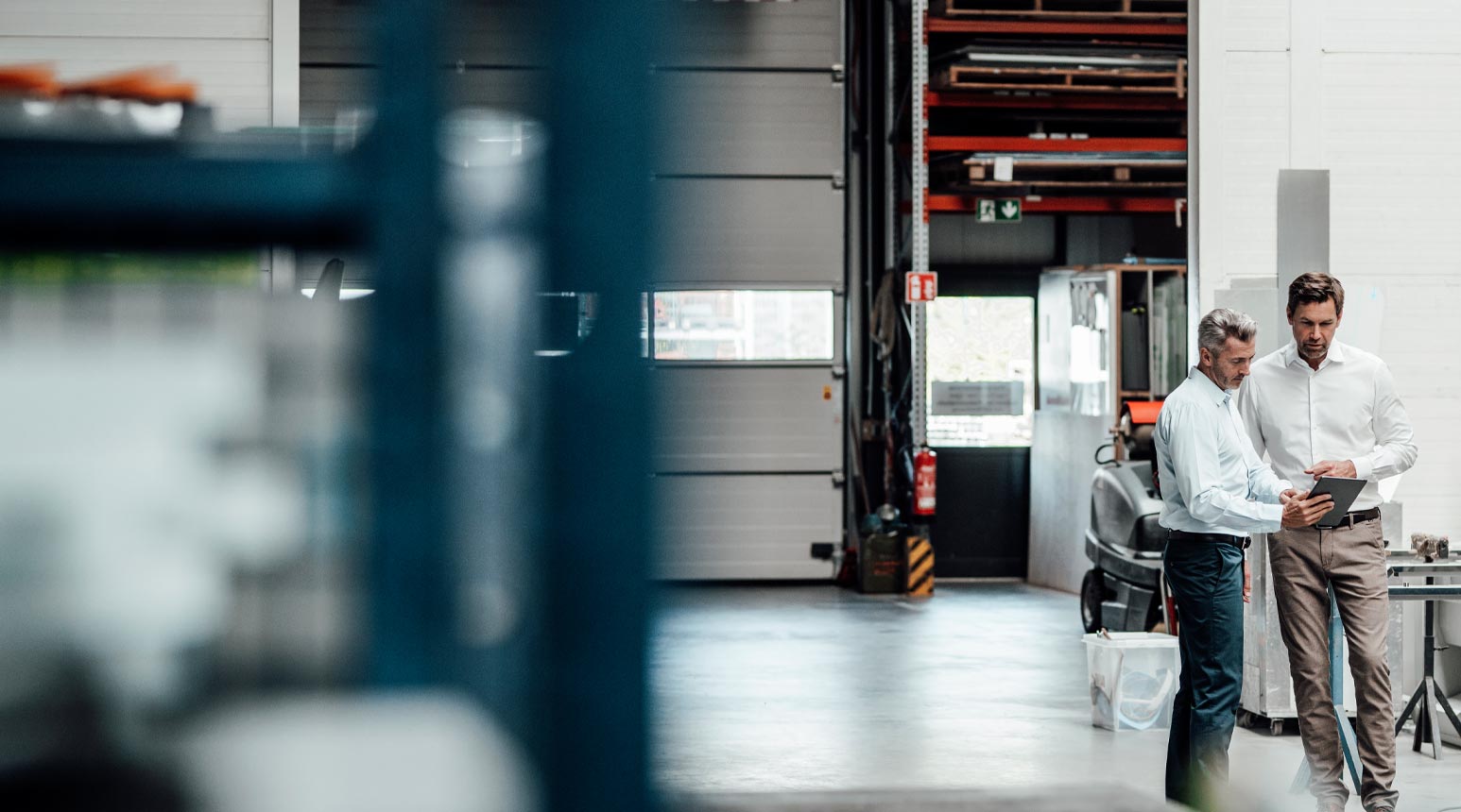 Two men investigating a claim inside a warehouse.